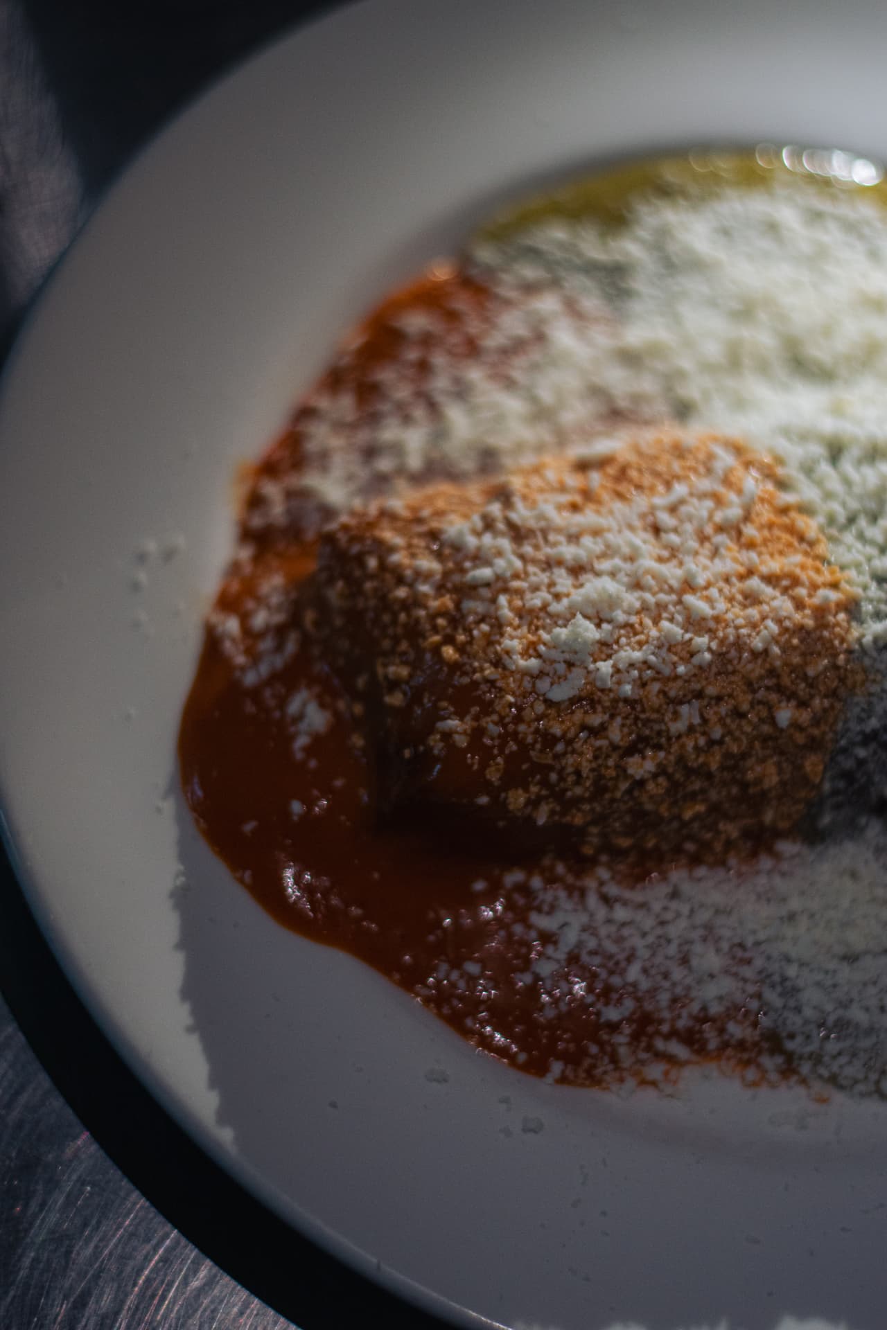 Loaded tamale with red sauce and cheese