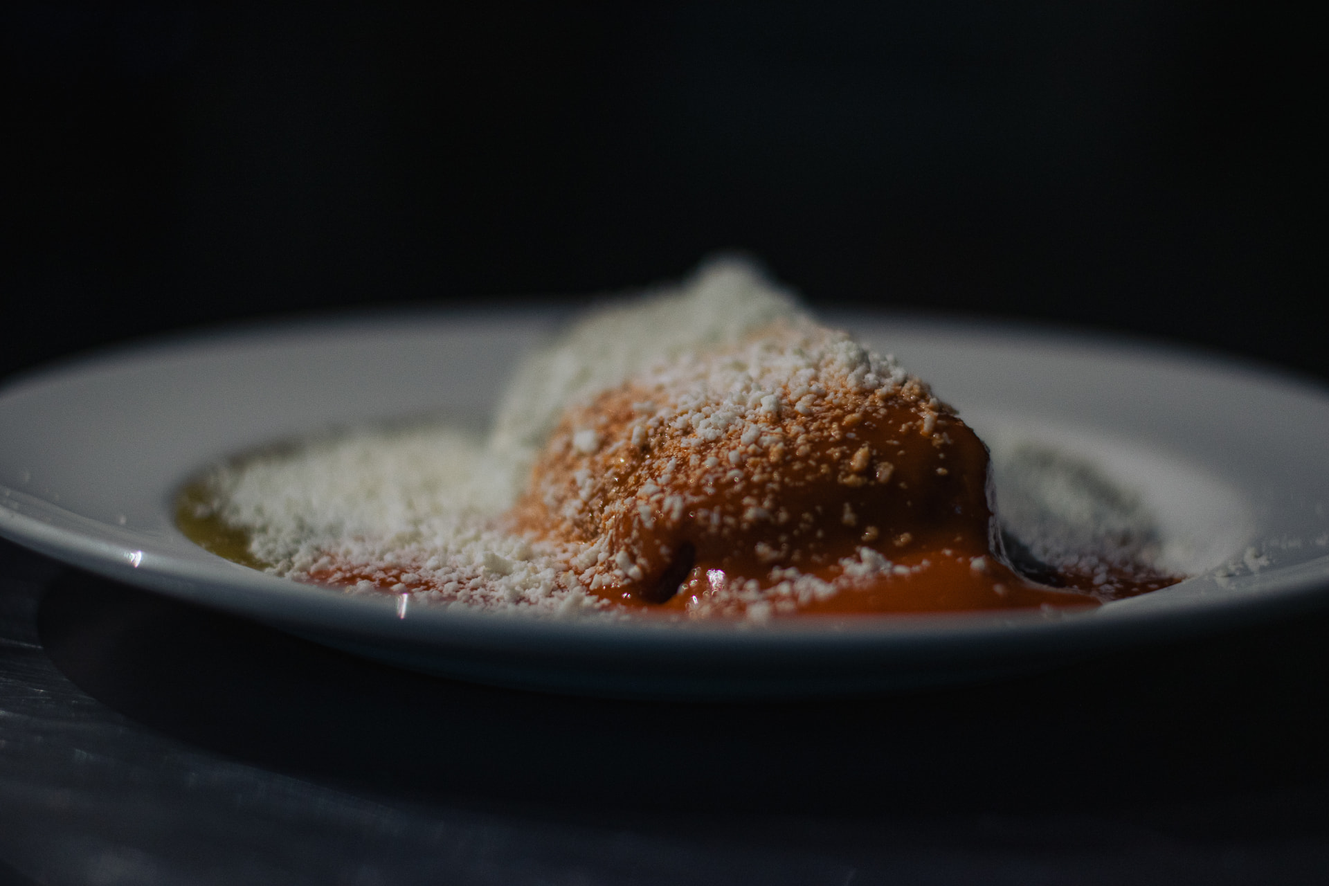 Loaded tamale with red sauce and cheese